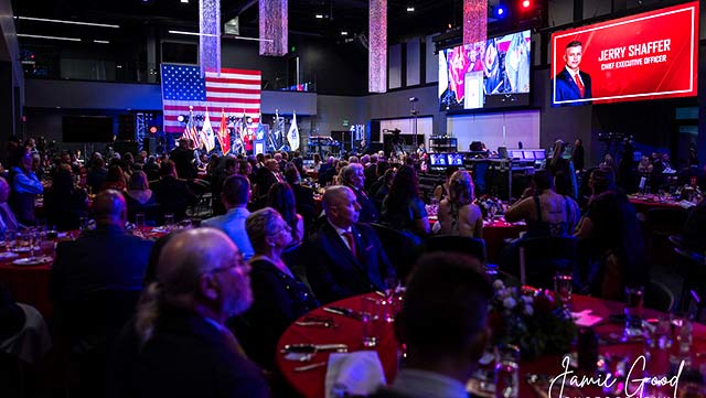 Guests gathered at the inaugural Red Star Gala, with an American flag and a screen recognizing CEO Jerry Shaffer